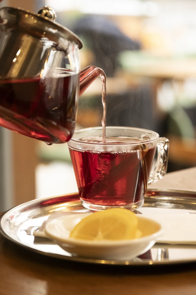 Pomegranate blossom tea poured from a teapot