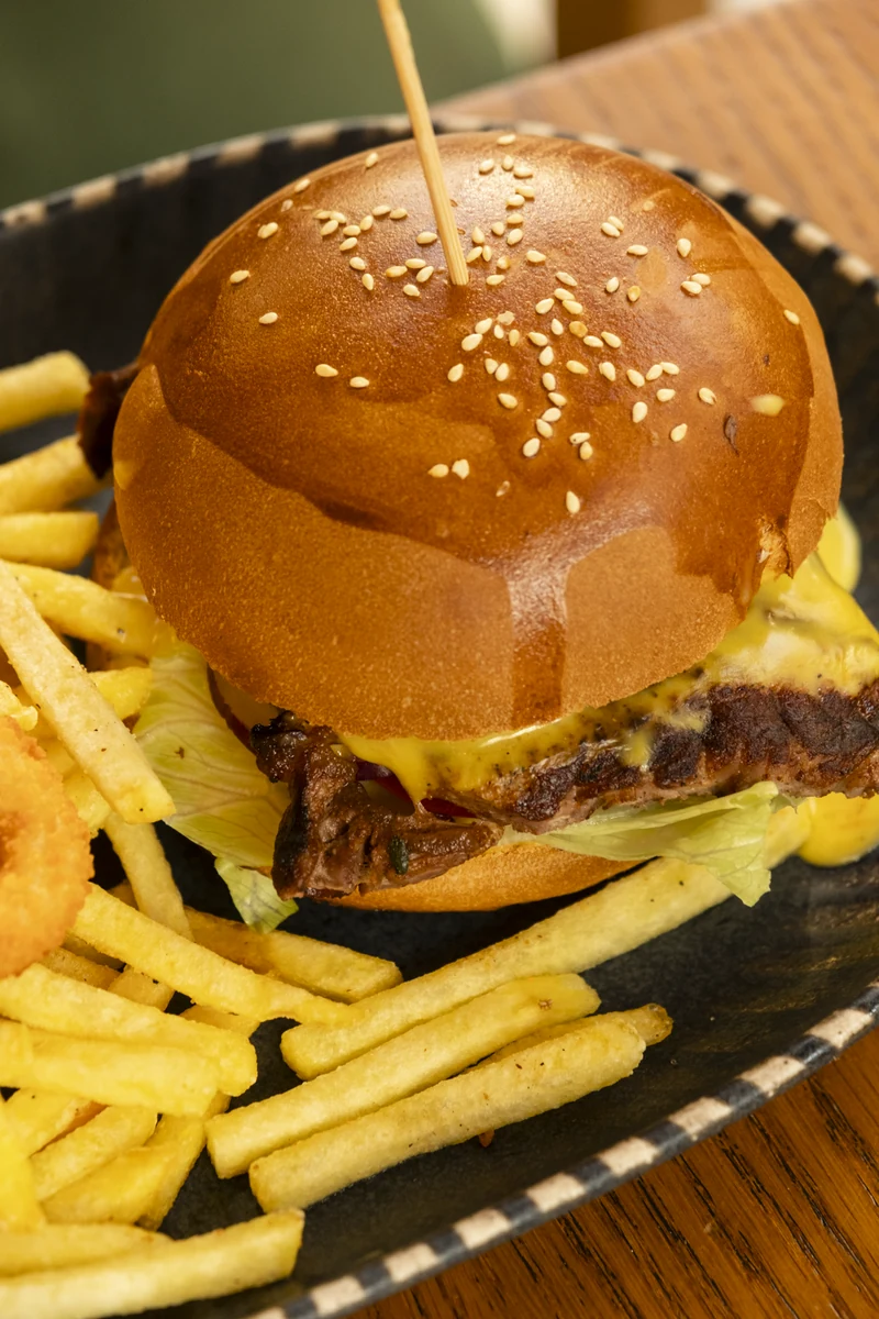 Firuz Burger on a sesame bun with fries