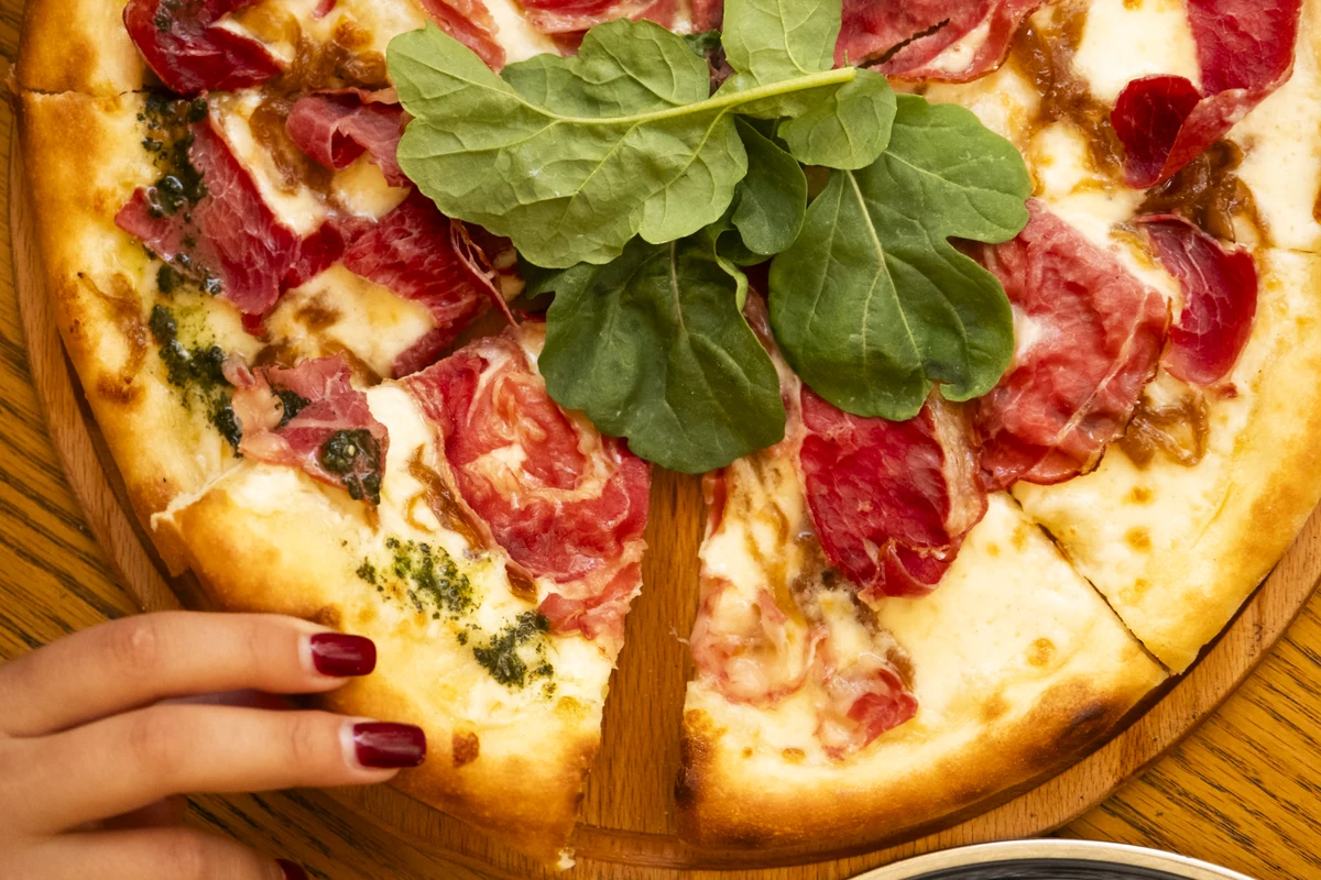 Pizza with smoked beef and rocket